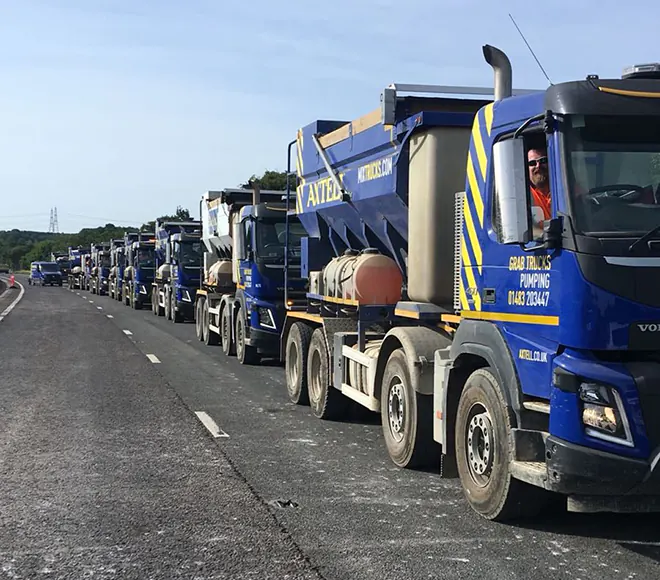 Line of Axtell's specialist highways concrete trucks on road